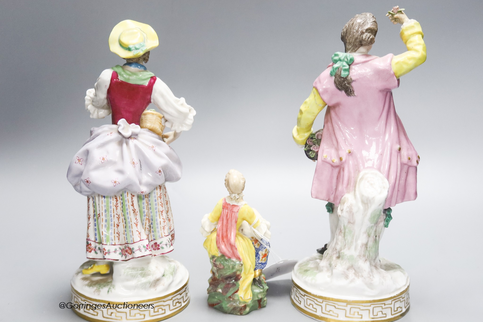 A pair of Continental porcelain figures and smaller, English figure